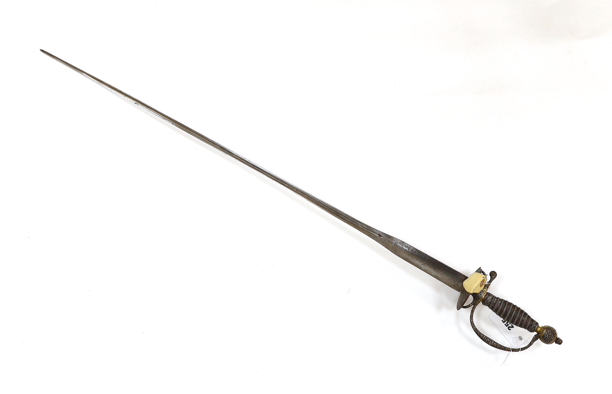 A French iron hilted small sword, hilt with flutes and tiny gold dots, the knuckle guard with key decoration, iron tape and silver wire bound grip, colichemarde blade with etched strapwork decoration, c.1770, blade 83cm